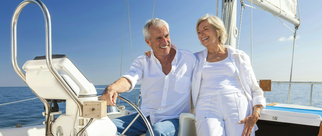 retired couple on sale boat on the ocean