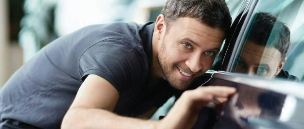 Man looking down the lines of his new car