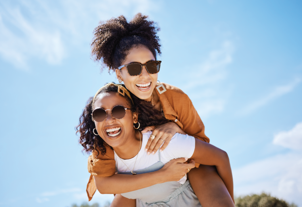 woman being carried by another woman on her back