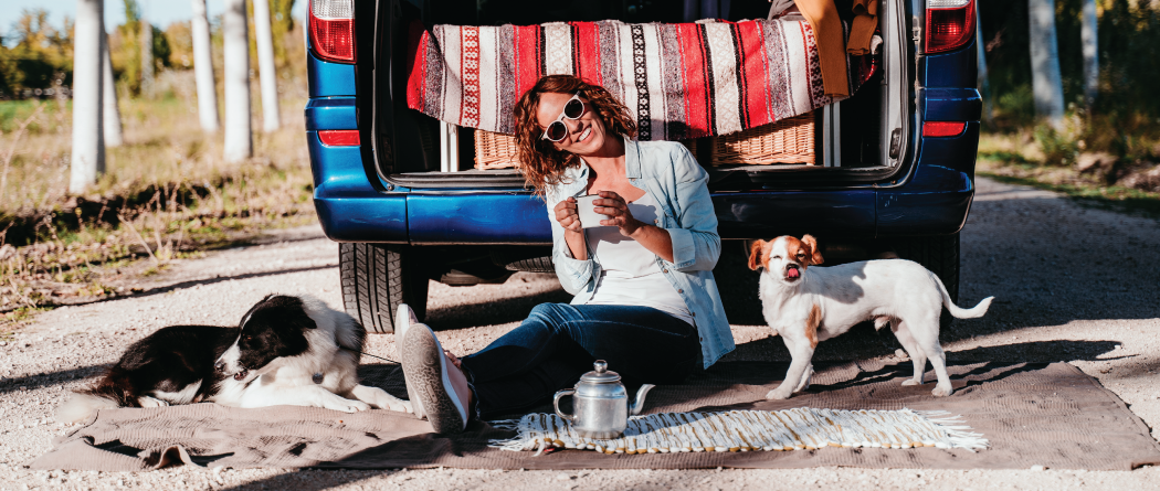 owman having coffee with her dogs outside of tailgate