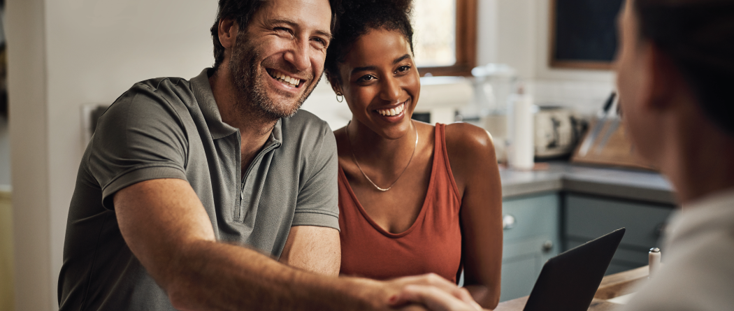 couple meeting with financial advisor in kitchen