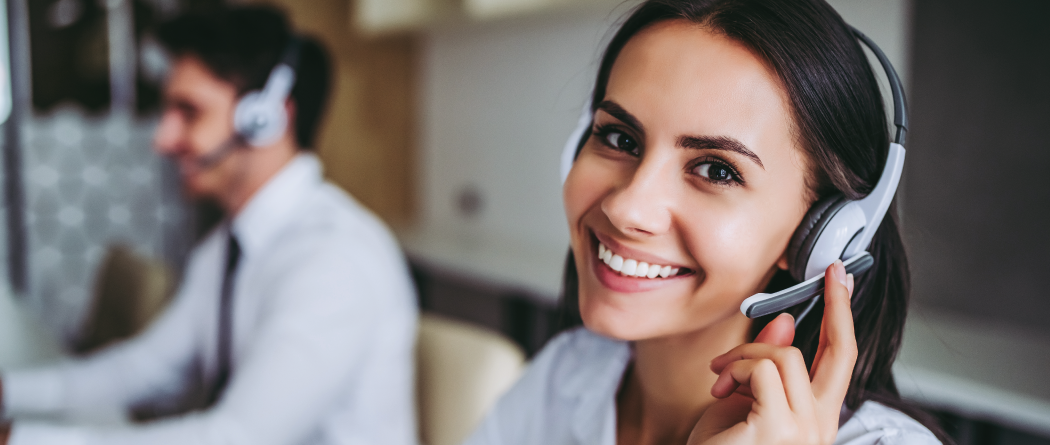 Call center rep smiling with headset on