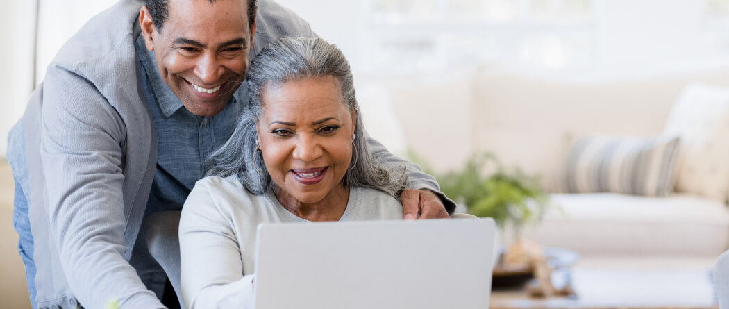 mature couple looking at a laptop