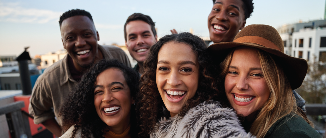 Group of young adults taking a selfie while outside