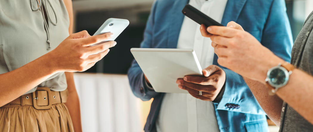 Group of businesspeople holding tech devices