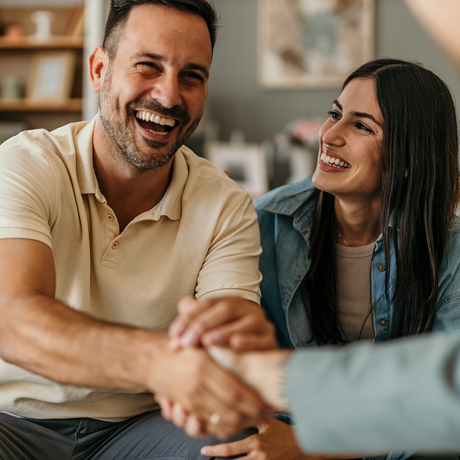 Couple shaking the hands of a financial advisor
