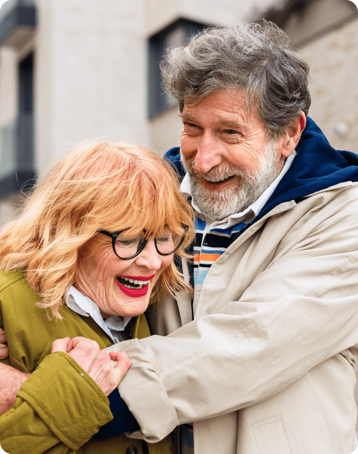 Older couple laughing and hugging each other