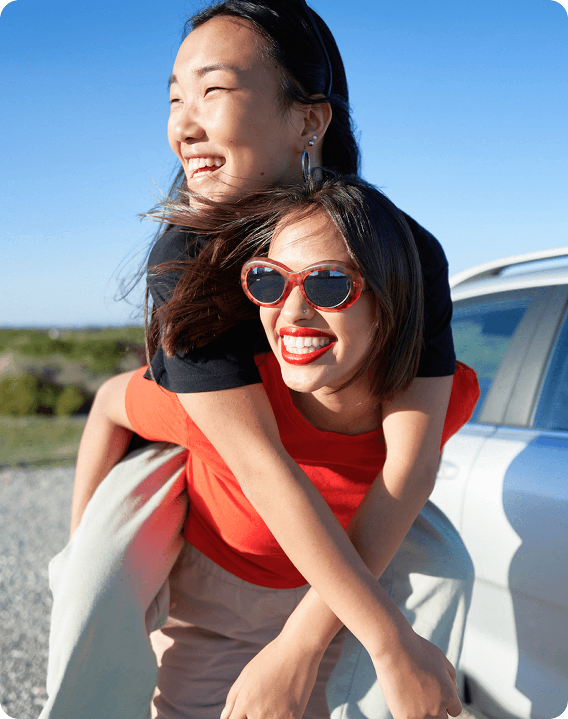 woman giving piggyback ride to another woman