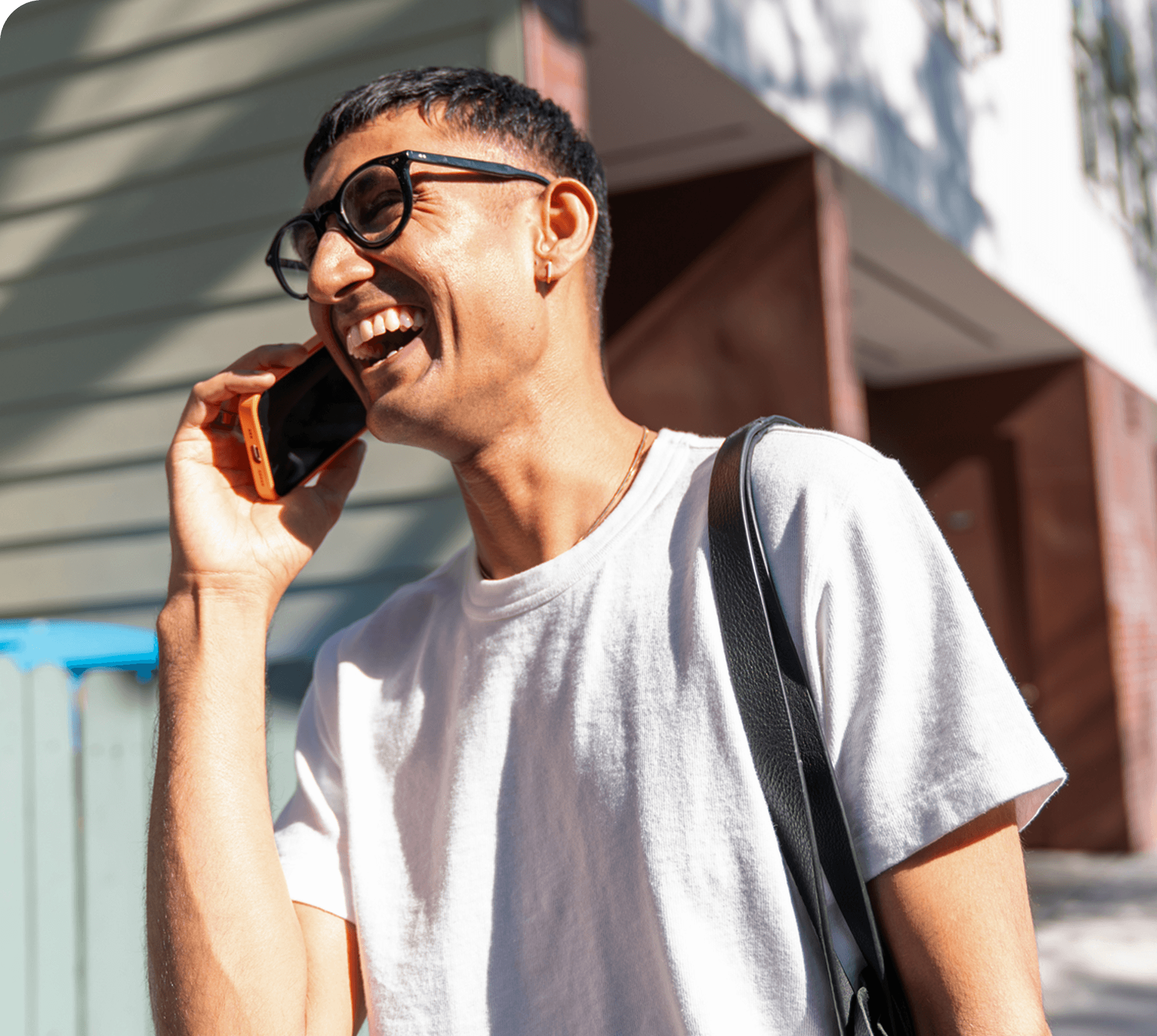 man talking on phone and laughing