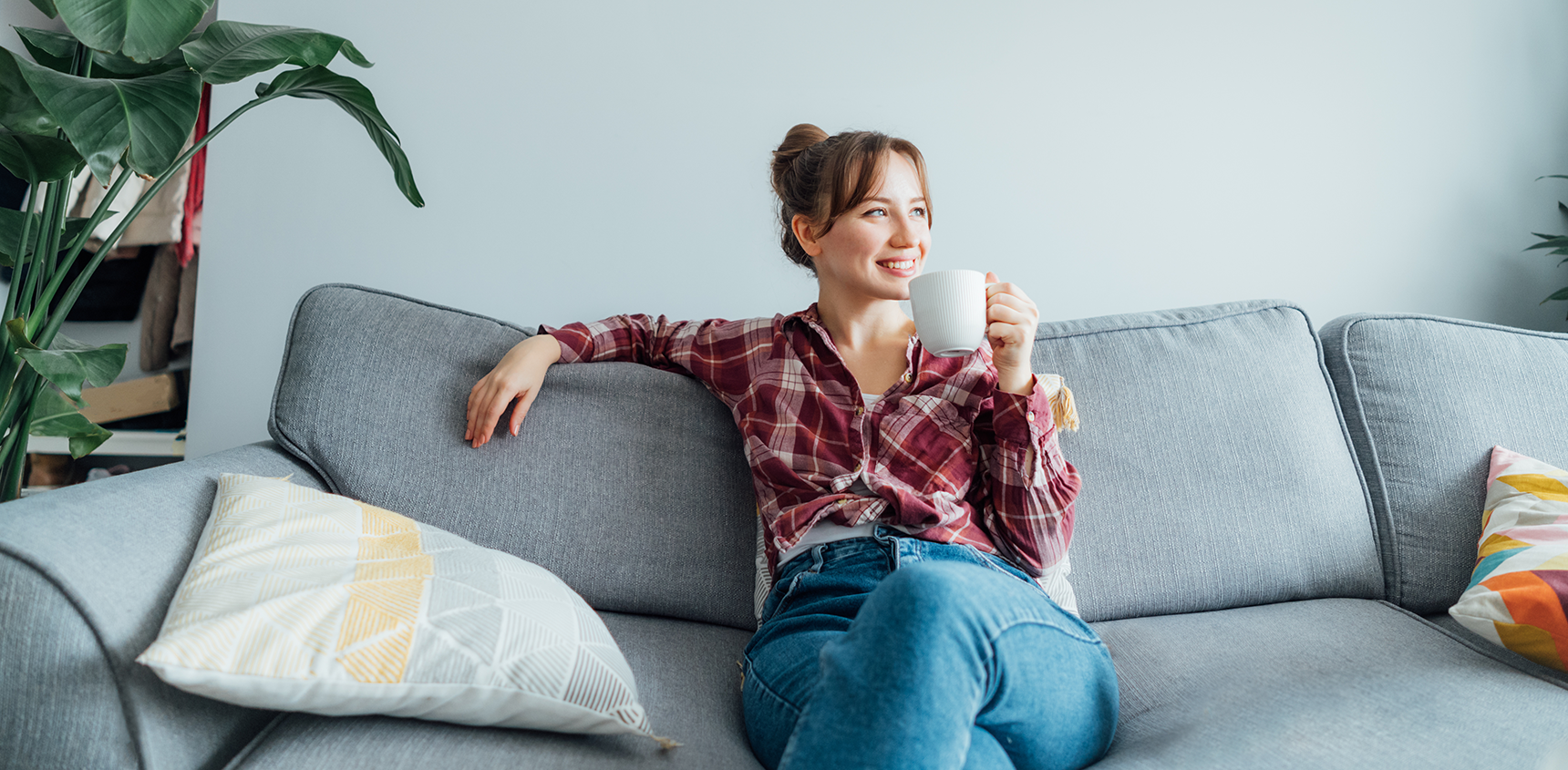 Woman sitting on couch holding a mug